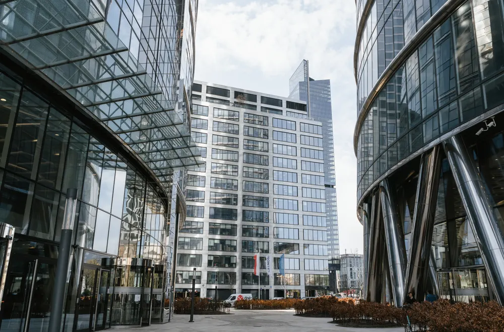 Glass office buildings surrounding a commercial plaza